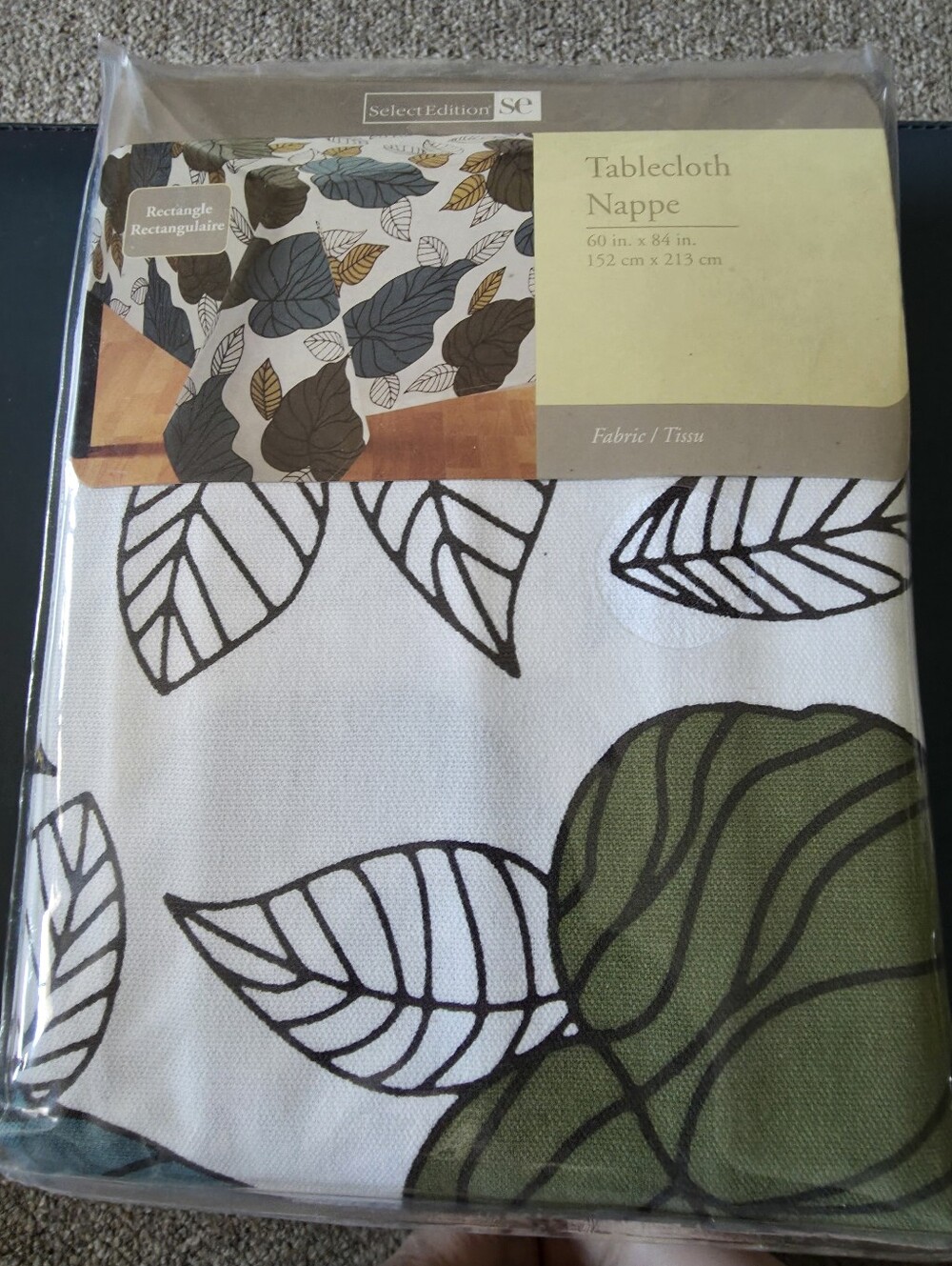 Select Edition "Leaves" rectangle tablecloth measuring 60 inches by 84 inches.